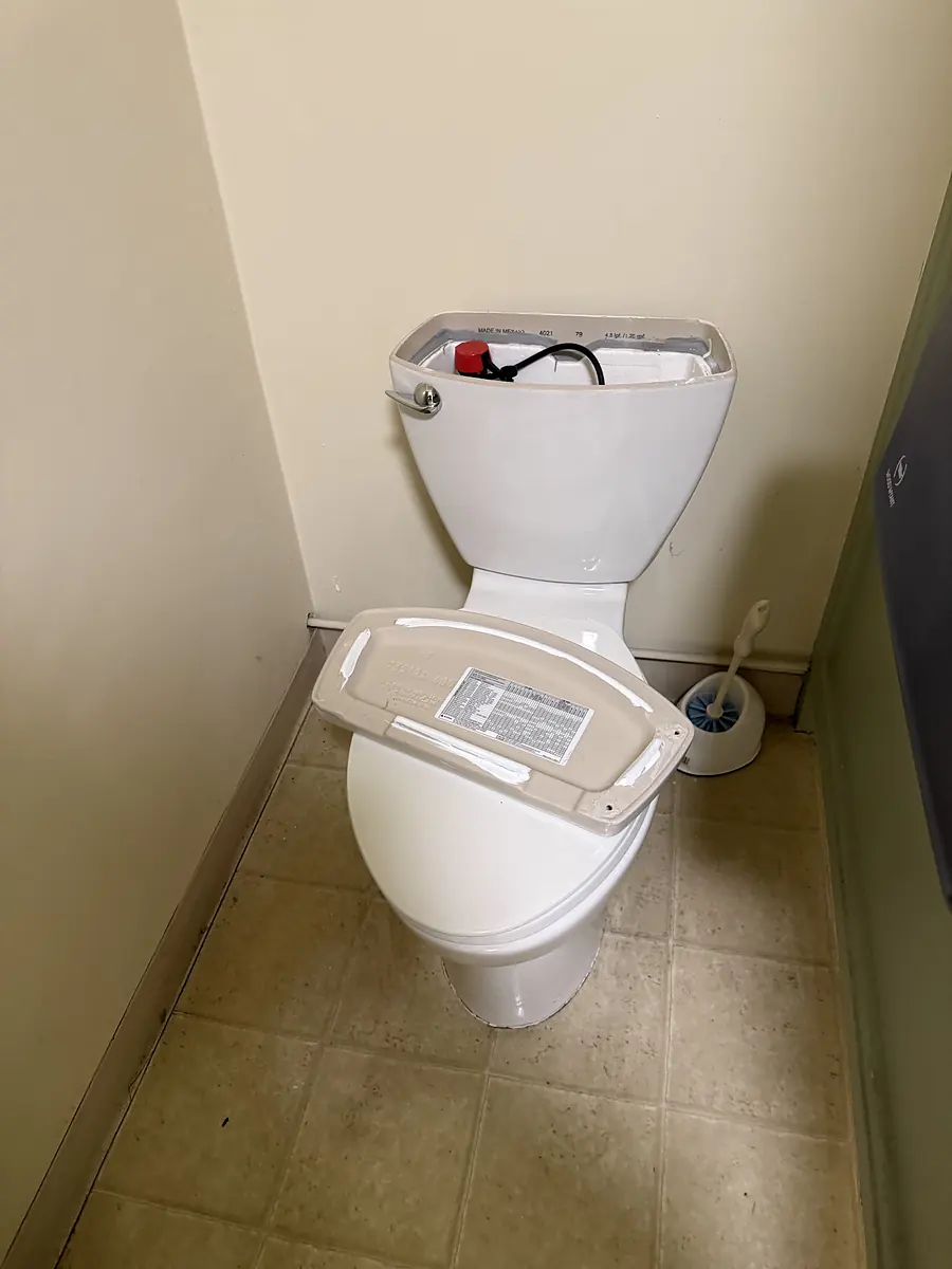 New toilet being installed in a small washroom